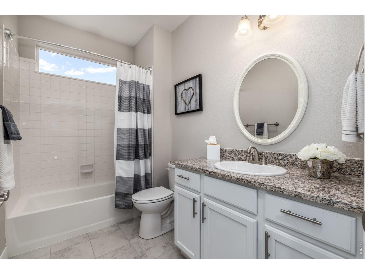 3789 Bridle Ridge Circle Severance, CO 80524 - Photo 31 of 44 a bathroom with a granite countertop toilet a sink and a mirror