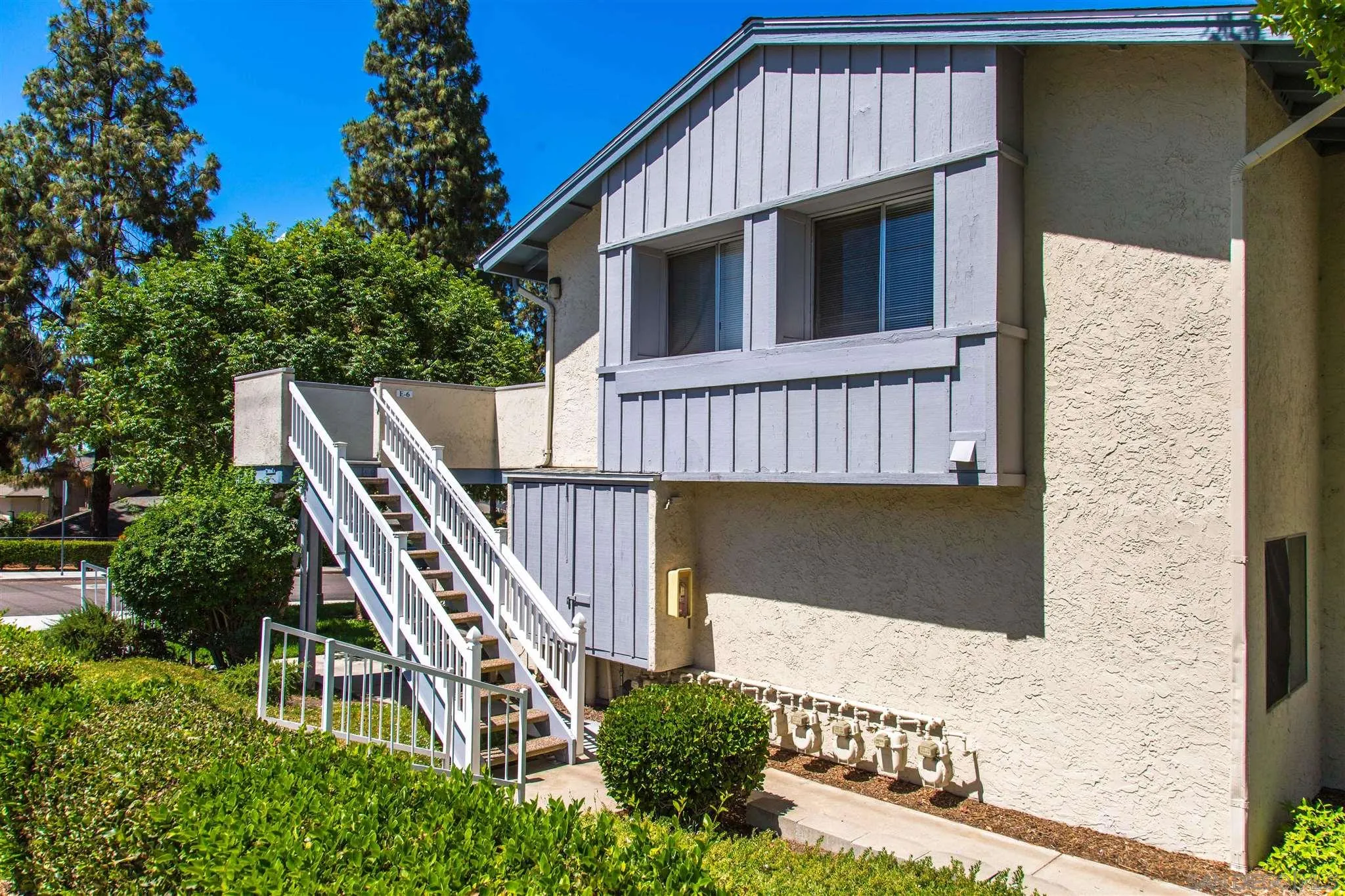 a front view of a house with wooden stairs