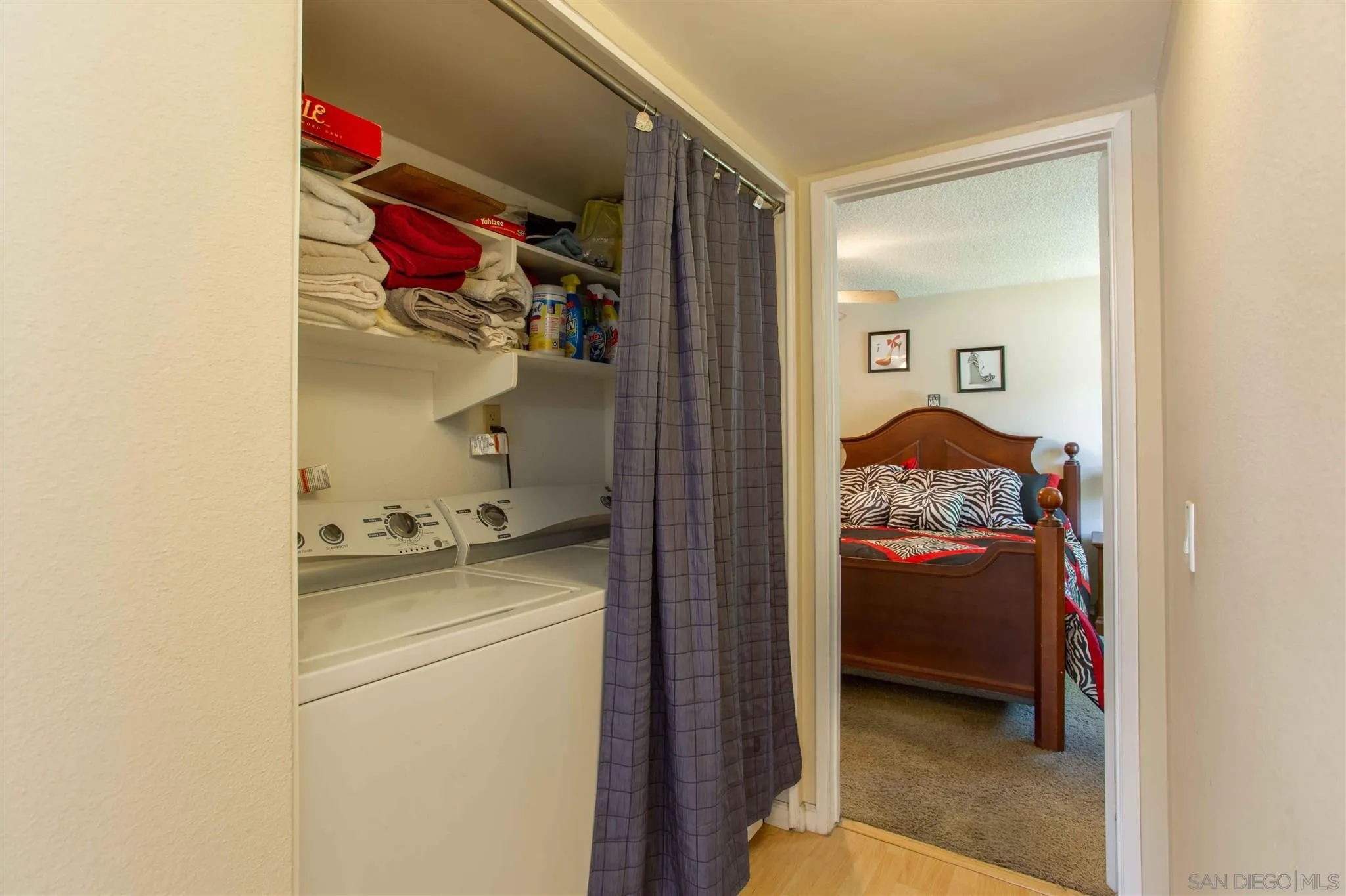 10384 Alphonse Street, Unit E6 Santee, CA 92071 - Photo 13 of 26 a room that has a bed and a utility room in it