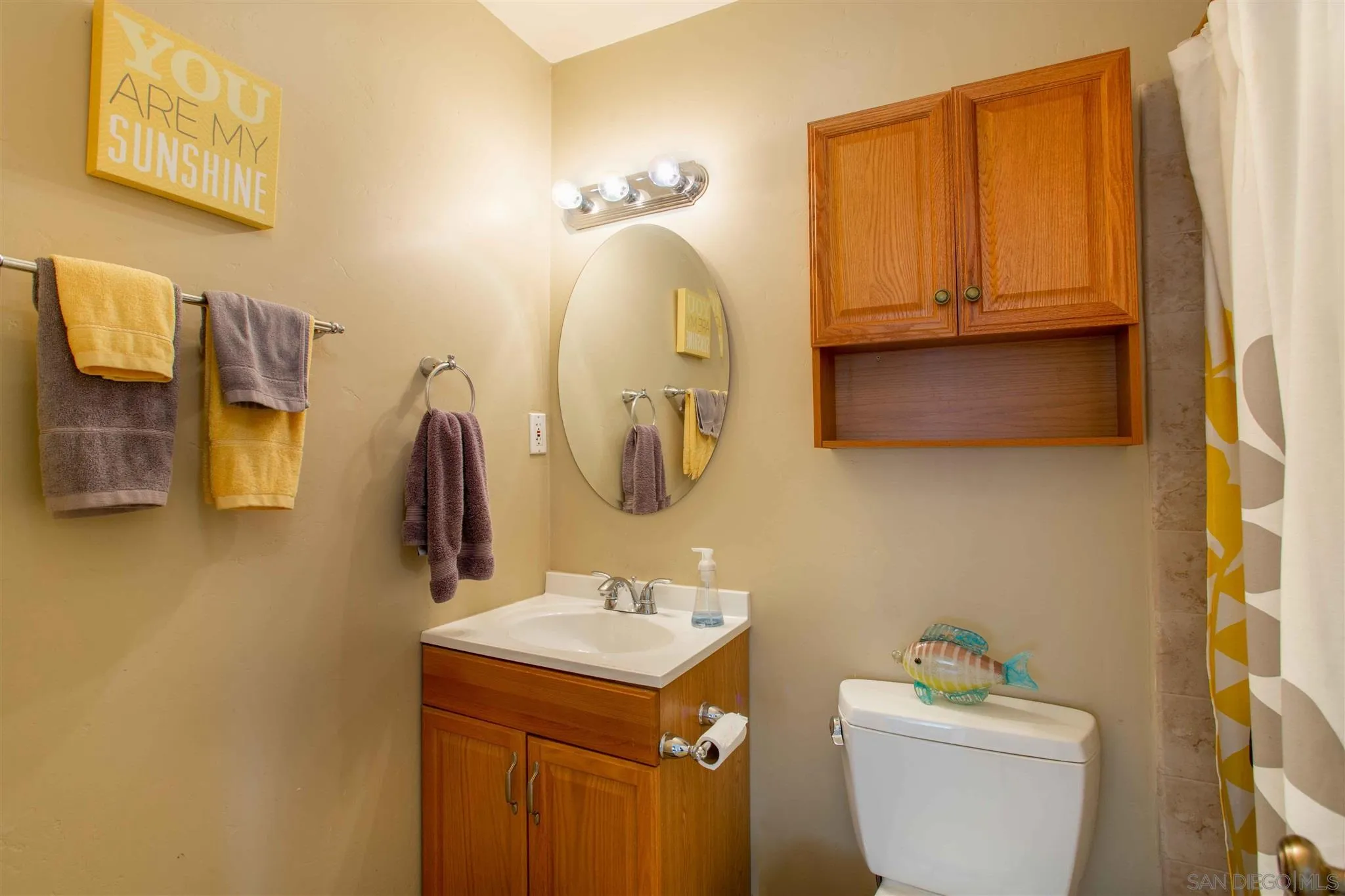 10384 Alphonse Street, Unit E6 Santee, CA 92071 - Photo 14 of 26 a bathroom with a sink toilet and mirror