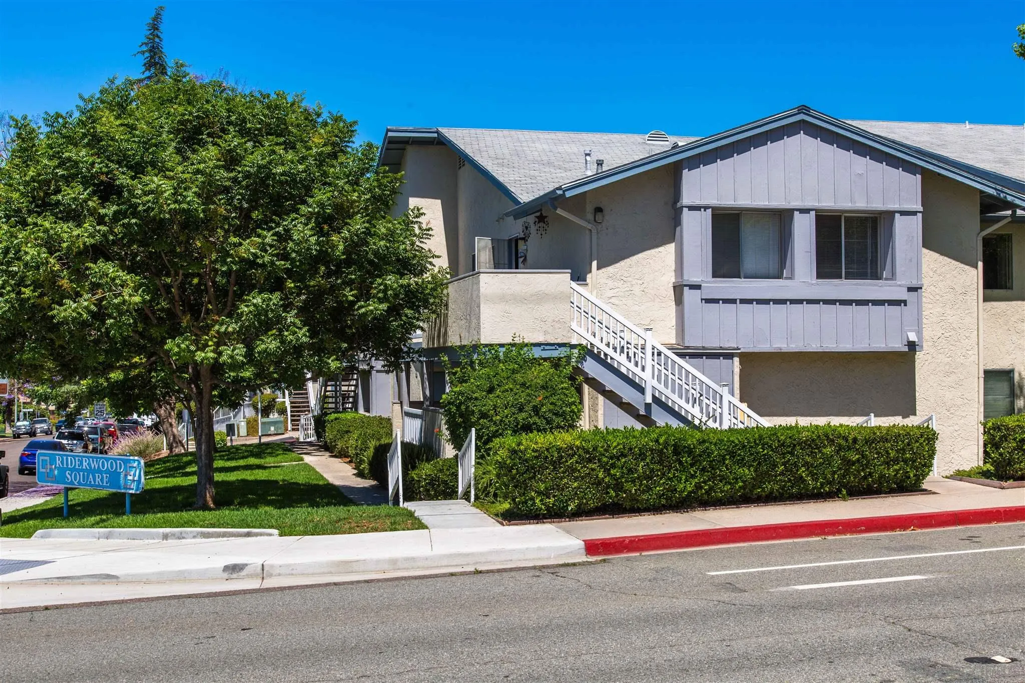 10384 Alphonse Street, Unit E6 Santee, CA 92071 - Photo 2 of 26 a front view of a house with a yard and garage
