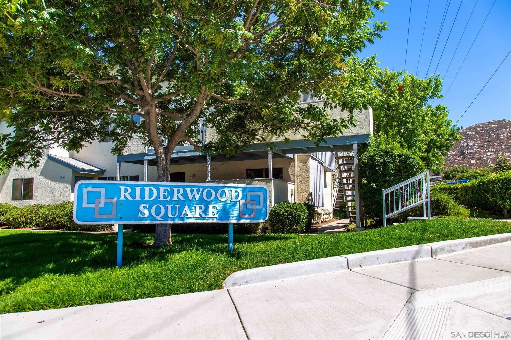 10384 Alphonse Street, Unit E6 Santee, CA 92071 - Photo 26 of 26 a view of a deck that has a table and chairs with wooden fence and large trees