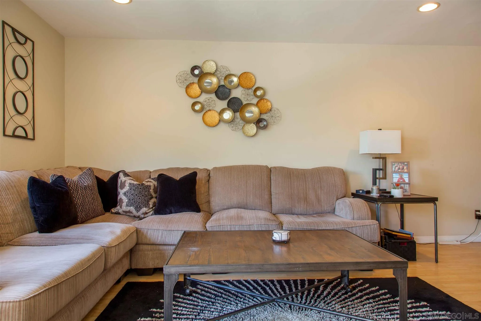 10384 Alphonse Street, Unit E6 Santee, CA 92071 - Photo 5 of 26 a living room with a couch and painting on the wall