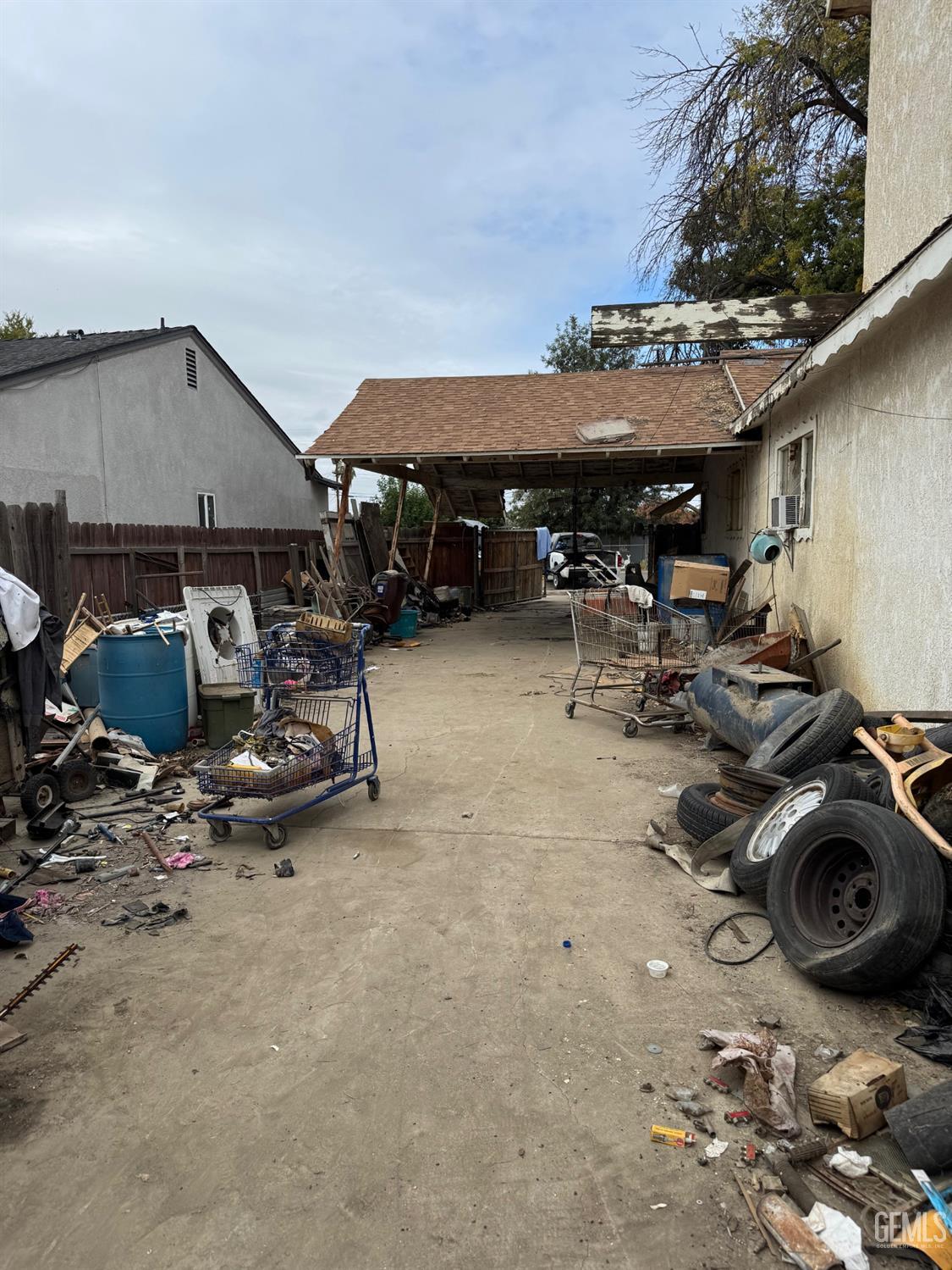 Undisclosed Address Bakersfield, CA 93307 - Photo 7 of 10 a view of a patio with table and chairs under an umbrella