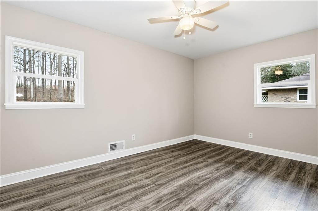 4319 Tradition Terrace Austell, GA 30106 - Photo 11 of 46 a view of an empty room with wooden floor and a window