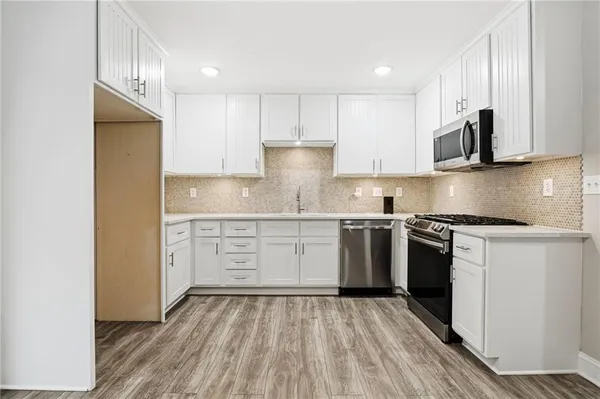 a kitchen with stainless steel appliances granite countertop a stove and a sink