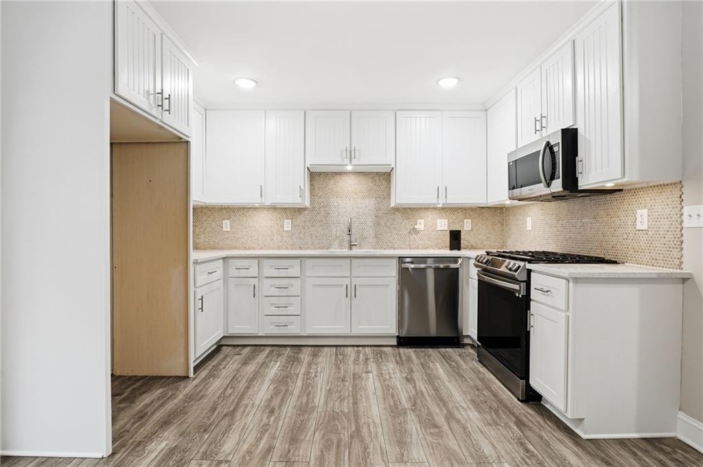 4319 Tradition Terrace Austell, GA 30106 - Photo 13 of 46 a kitchen with stainless steel appliances granite countertop a stove and a sink