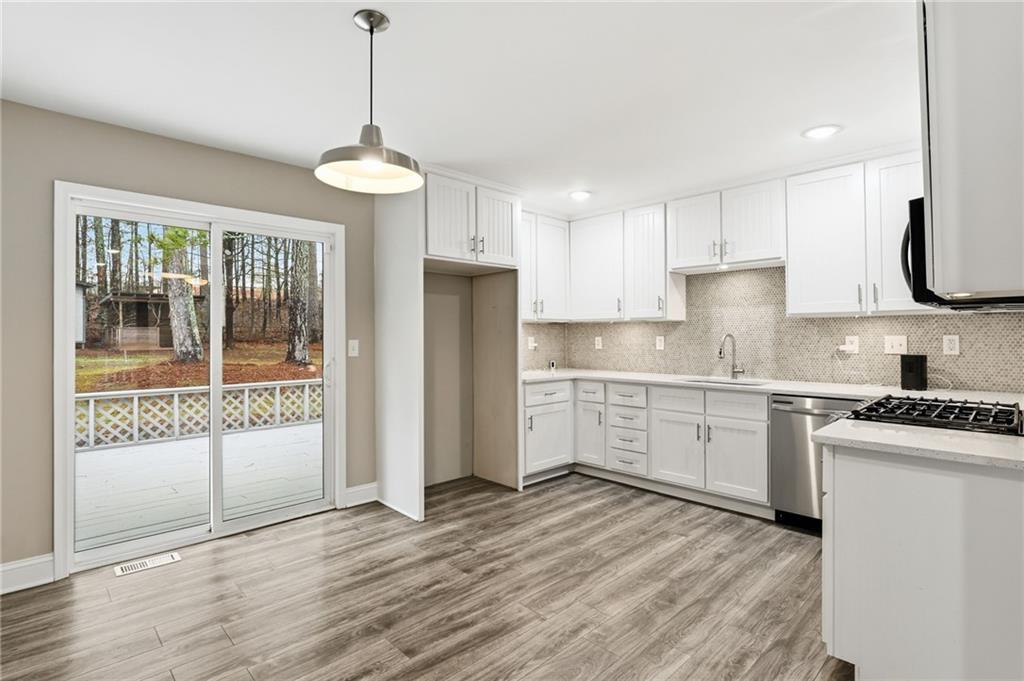 4319 Tradition Terrace Austell, GA 30106 - Photo 14 of 46 a kitchen with granite countertop a stove a sink and a refrigerator