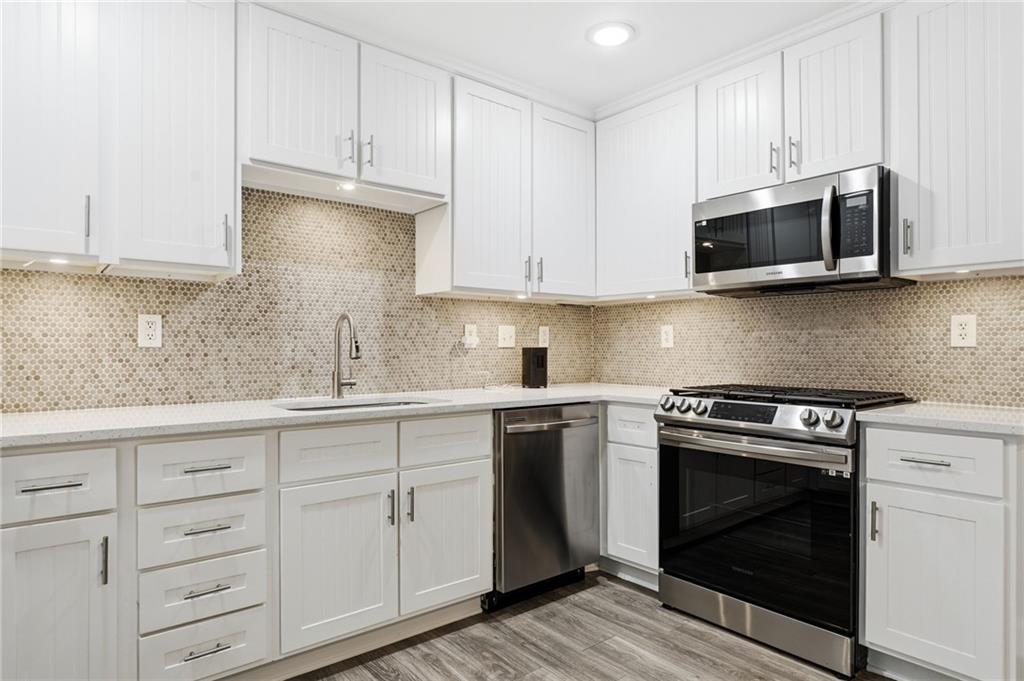 4319 Tradition Terrace Austell, GA 30106 - Photo 15 of 46 a kitchen with white cabinets and stainless steel appliances
