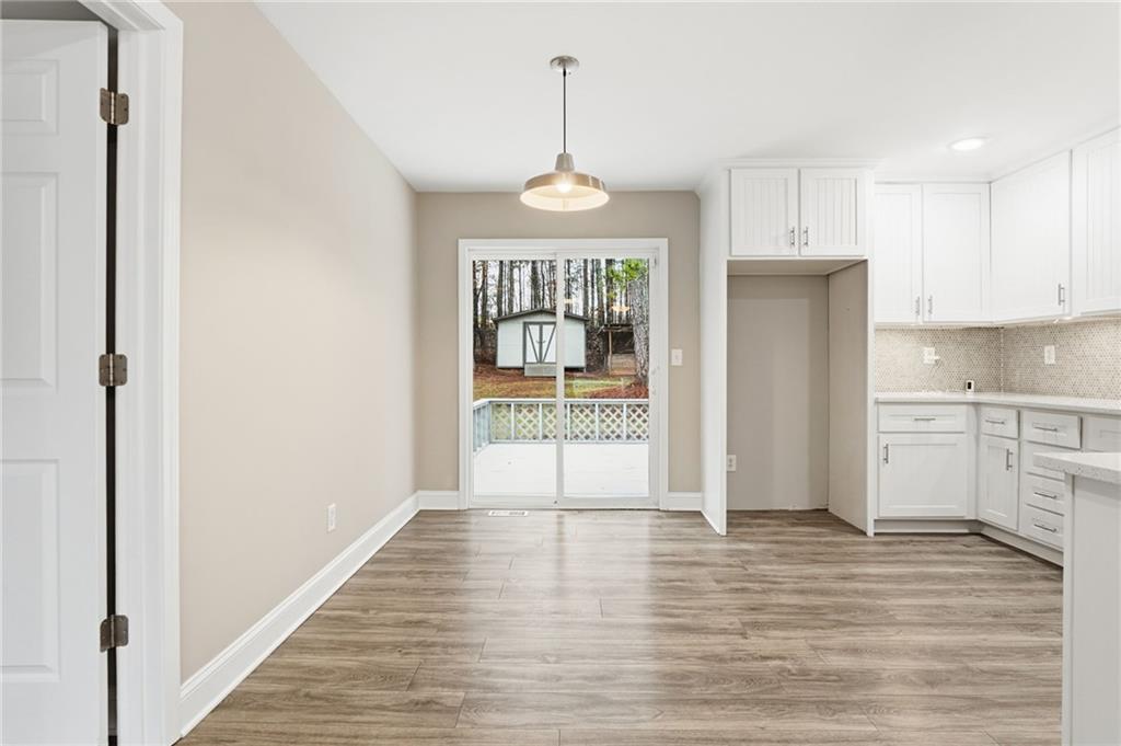 4319 Tradition Terrace Austell, GA 30106 - Photo 16 of 46 a view of a kitchen with an empty space and wooden floor