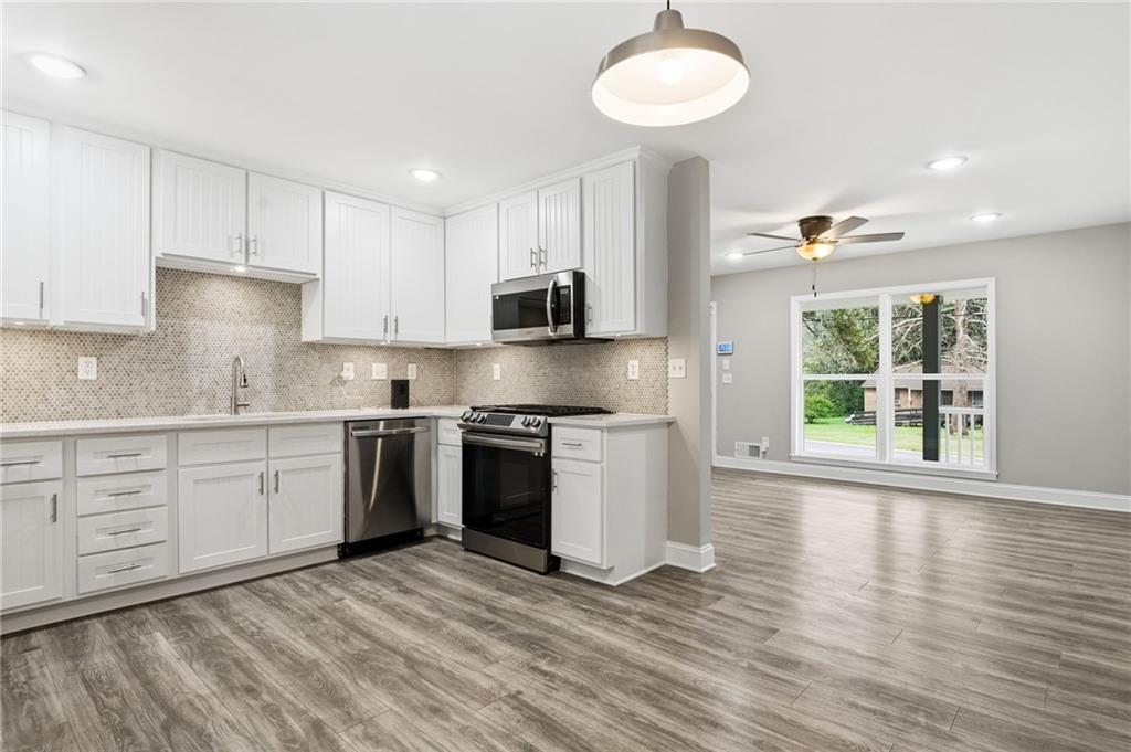 4319 Tradition Terrace Austell, GA 30106 - Photo 18 of 46 a kitchen with stainless steel appliances granite countertop a stove a sink and a microwave