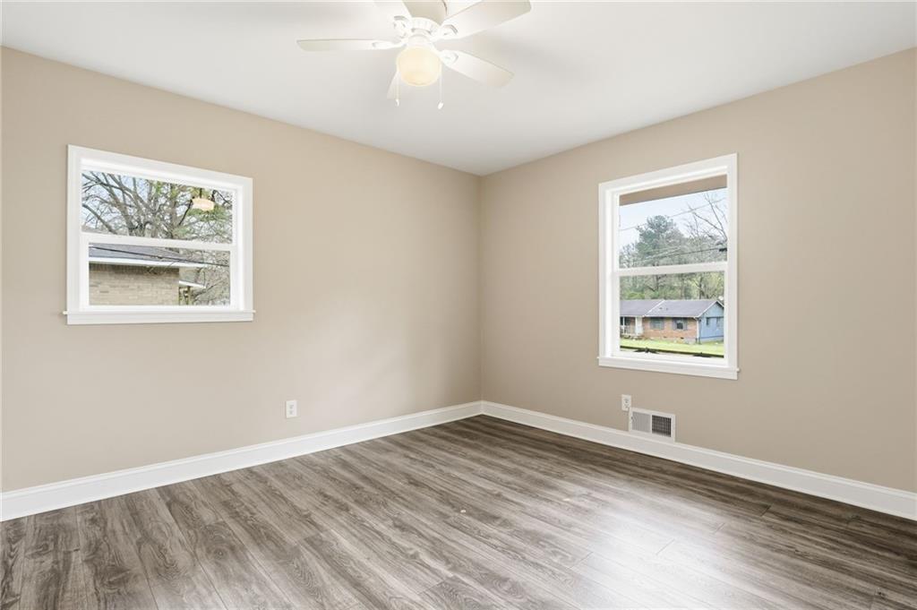 4319 Tradition Terrace Austell, GA 30106 - Photo 19 of 46 a view of an empty room with wooden floor and a window