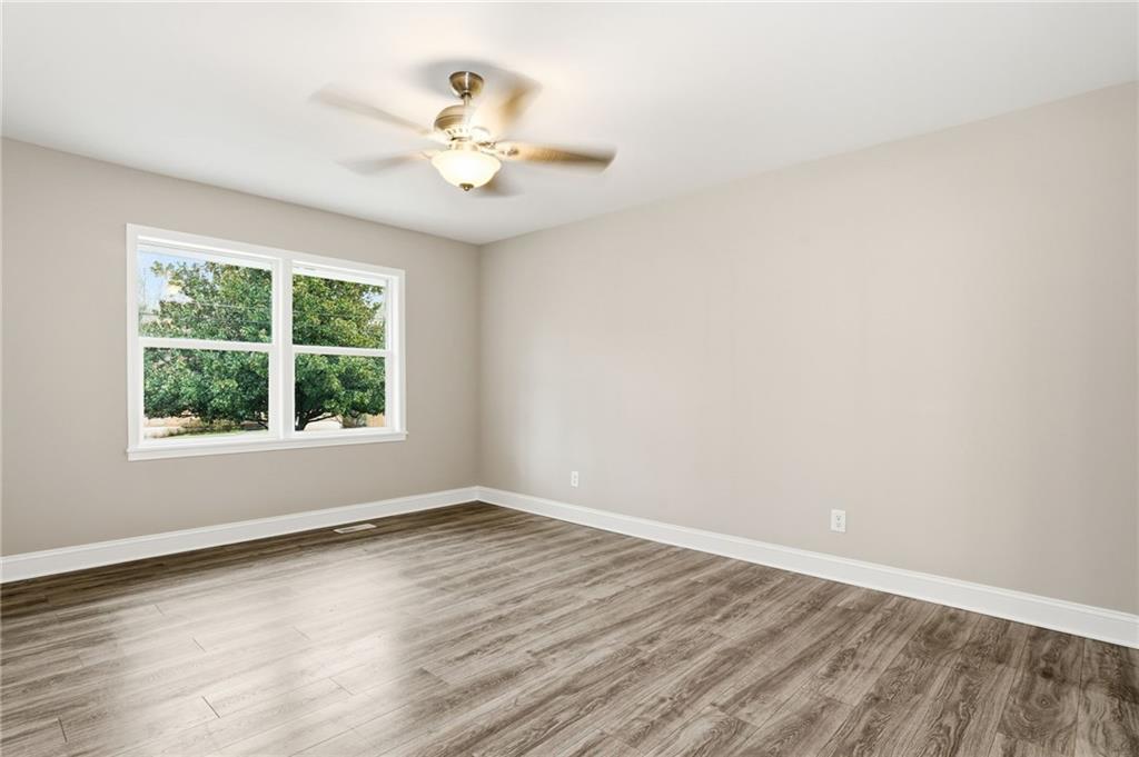4319 Tradition Terrace Austell, GA 30106 - Photo 24 of 46 a view of an empty room with wooden floor and a window