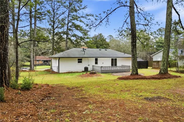 a view of a house with a large tree and a big yard