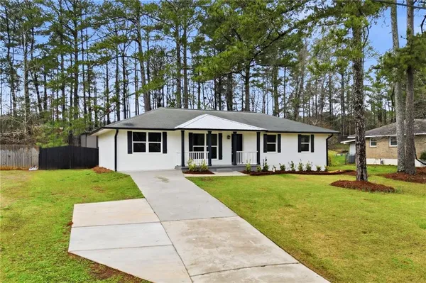 a front view of a house with a yard