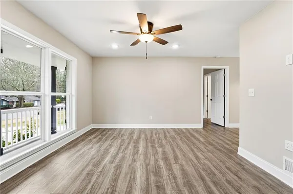 wooden floor in an empty room with a window