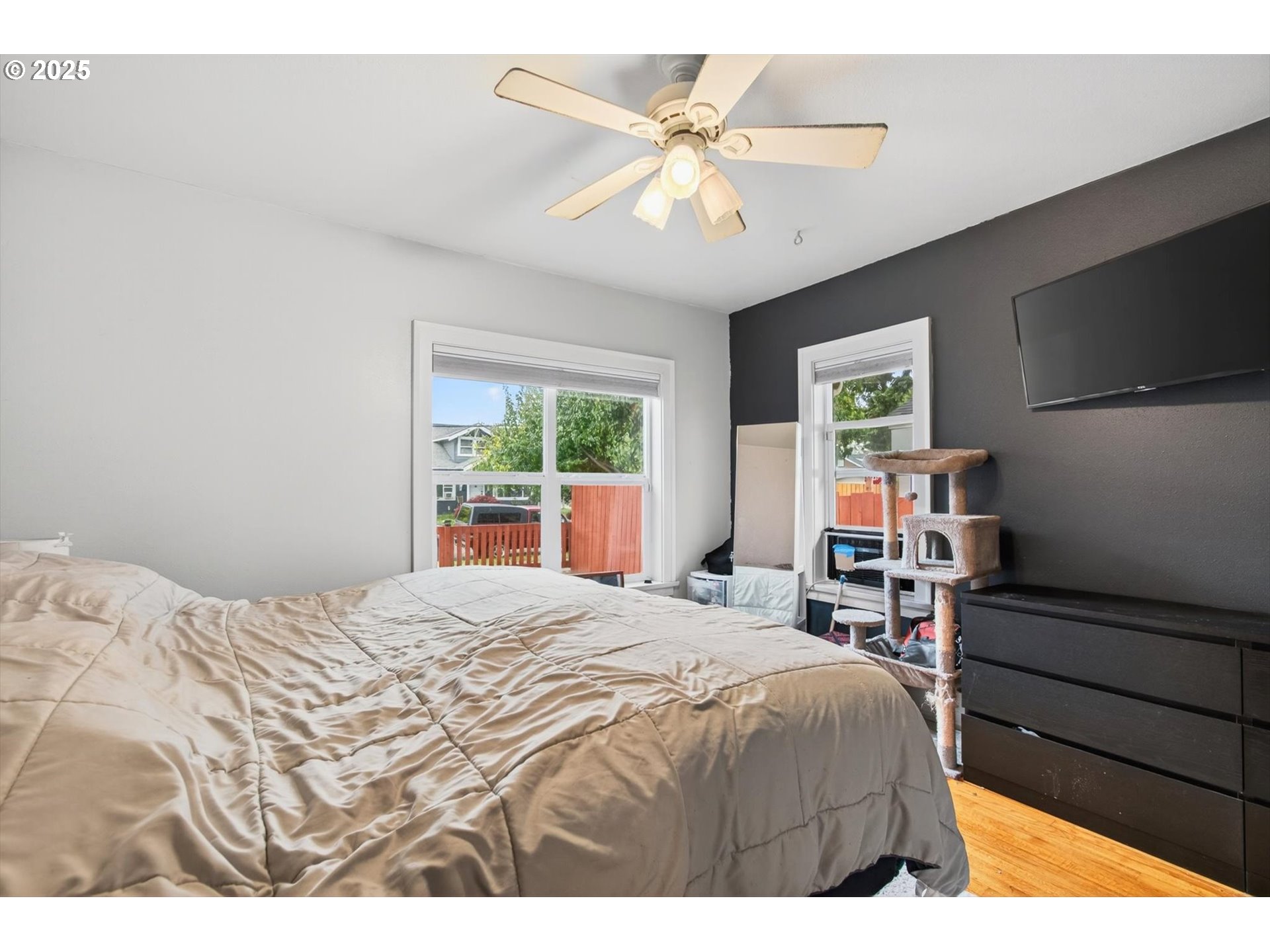 1202 3rd Avenue South Kelso, WA 98626 - Photo 17 of 28 a bedroom with a bed and a flat screen tv