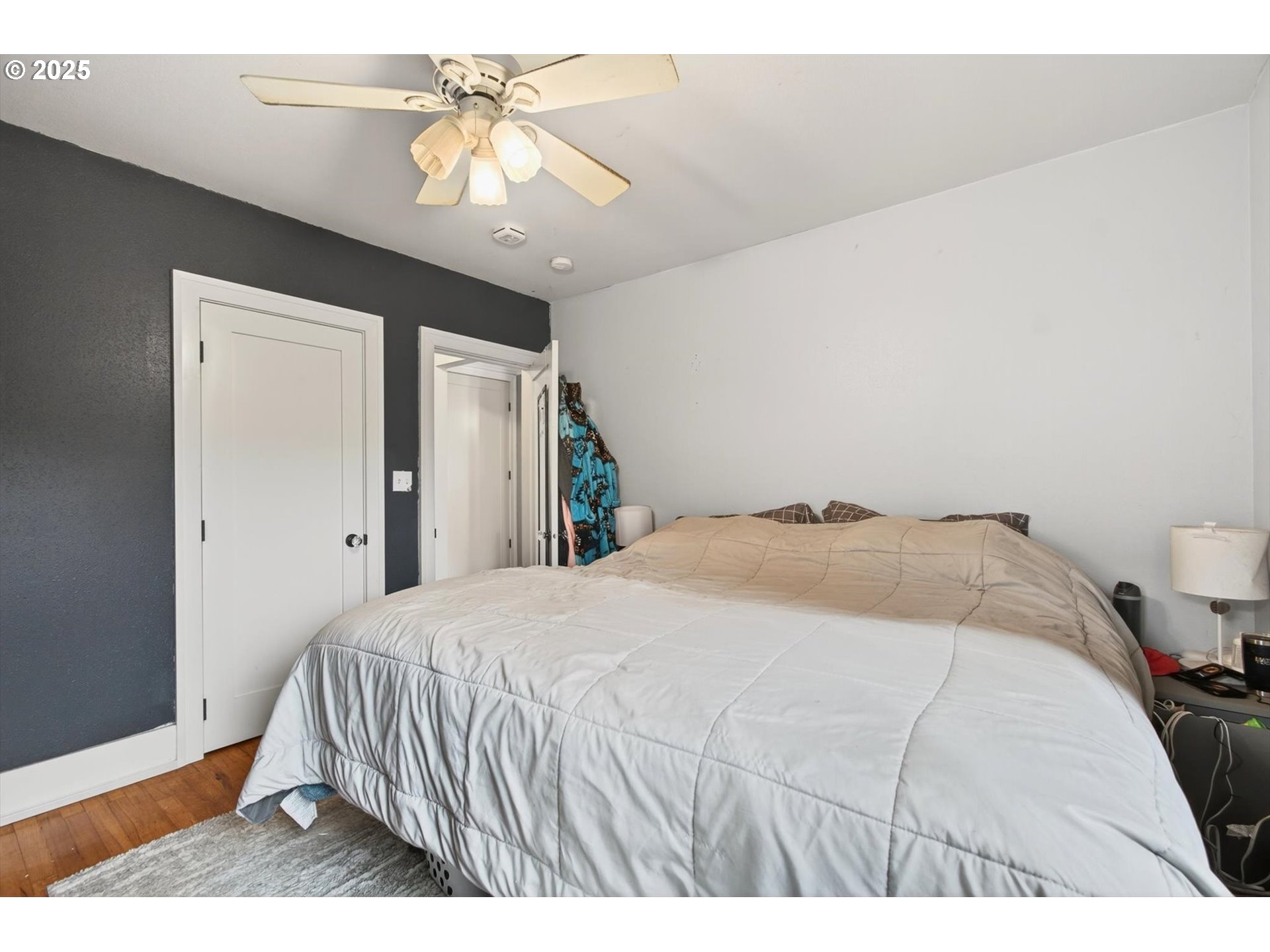 1202 3rd Avenue South Kelso, WA 98626 - Photo 18 of 28 a bedroom with a bed and a chandelier