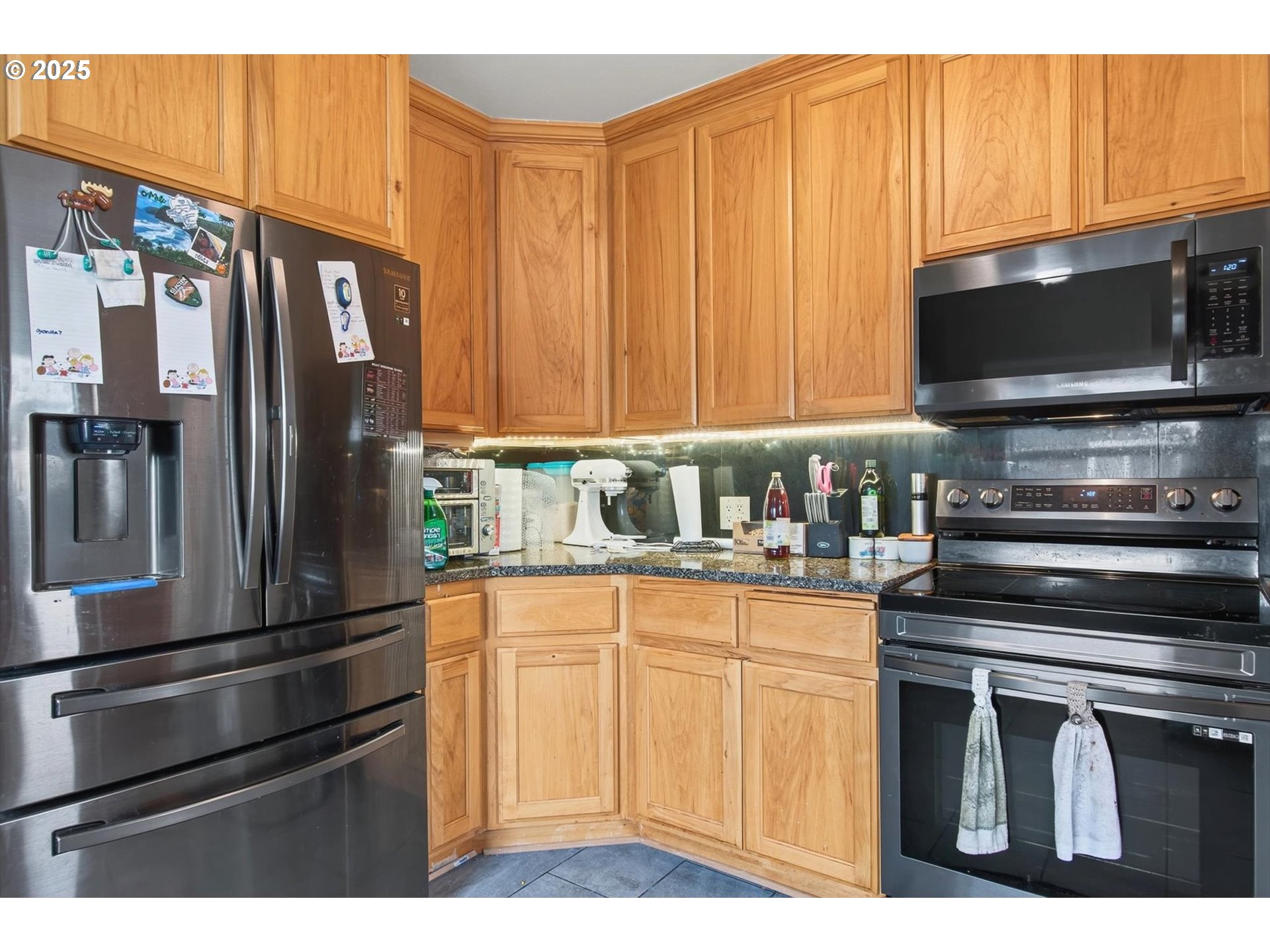 1202 3rd Avenue South Kelso, WA 98626 - Photo 19 of 28 a kitchen with stainless steel appliances a stove a microwave and a refrigerator