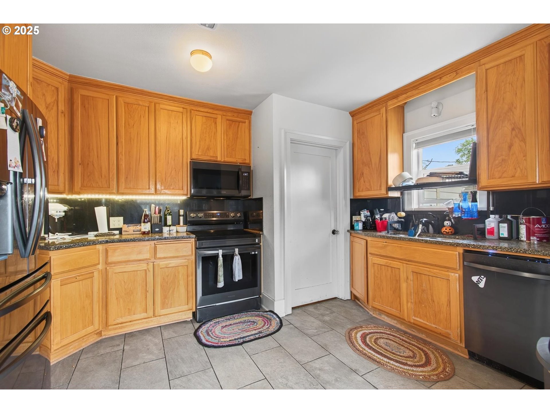 1202 3rd Avenue South Kelso, WA 98626 - Photo 21 of 28 a kitchen with stainless steel appliances granite countertop a stove a sink and a microwave