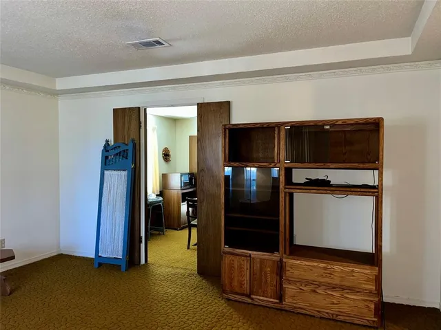 a view of kitchen with refrigerator and window