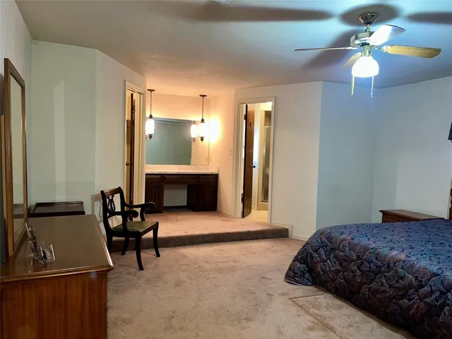 a bedroom with a bed and a fireplace