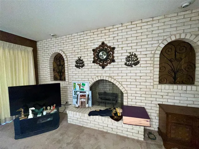 a living room with fireplace furniture and a fireplace