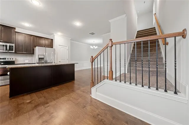 a view of kitchen with sink and refrigerator