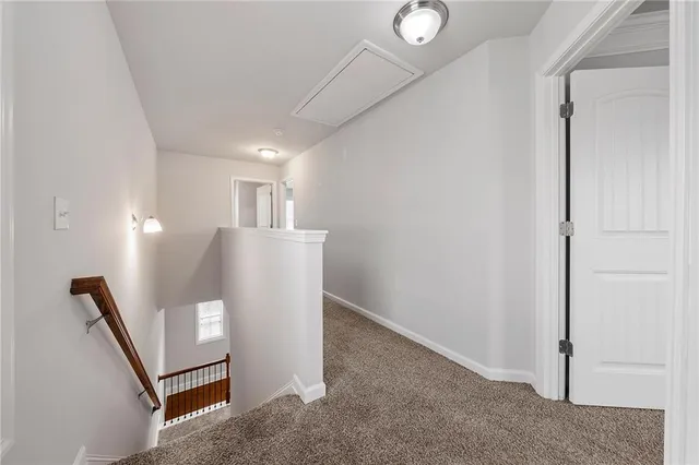 a view of a hallway to rooms