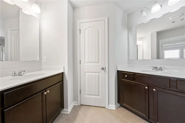 a bathroom with a double vanity sink and mirror