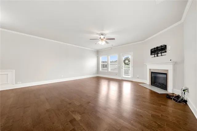 an empty room with windows and fireplace