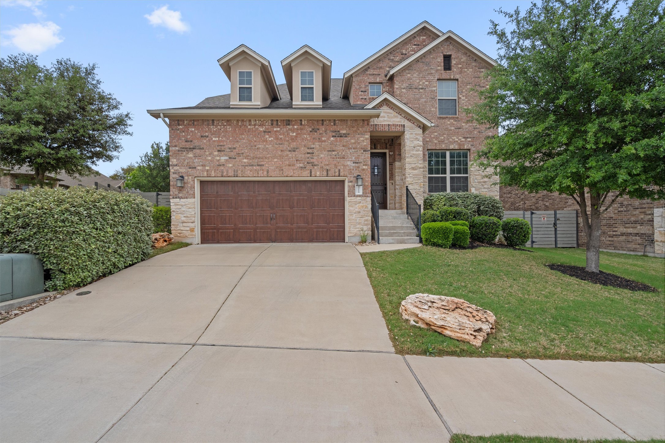 4216 Mercer Road Georgetown, TX 78628 - Photo 1 of 40 View of front facade with a front lawn, brick siding, driveway, and stone siding