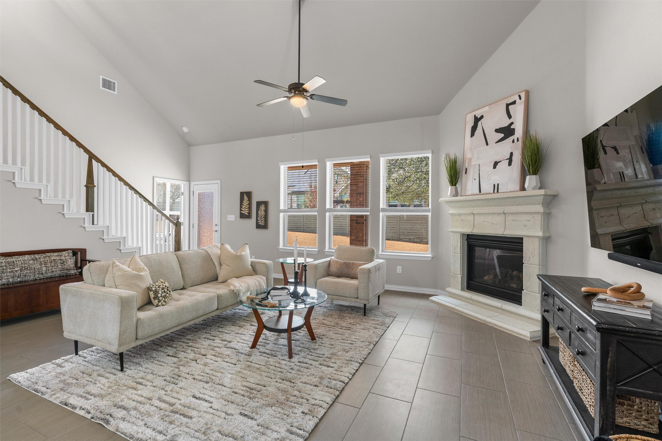 4216 Mercer Road Georgetown, TX 78628 - Photo 11 of 40 Living room featuring vaulted ceiling, ceiling fan, and gas fireplace