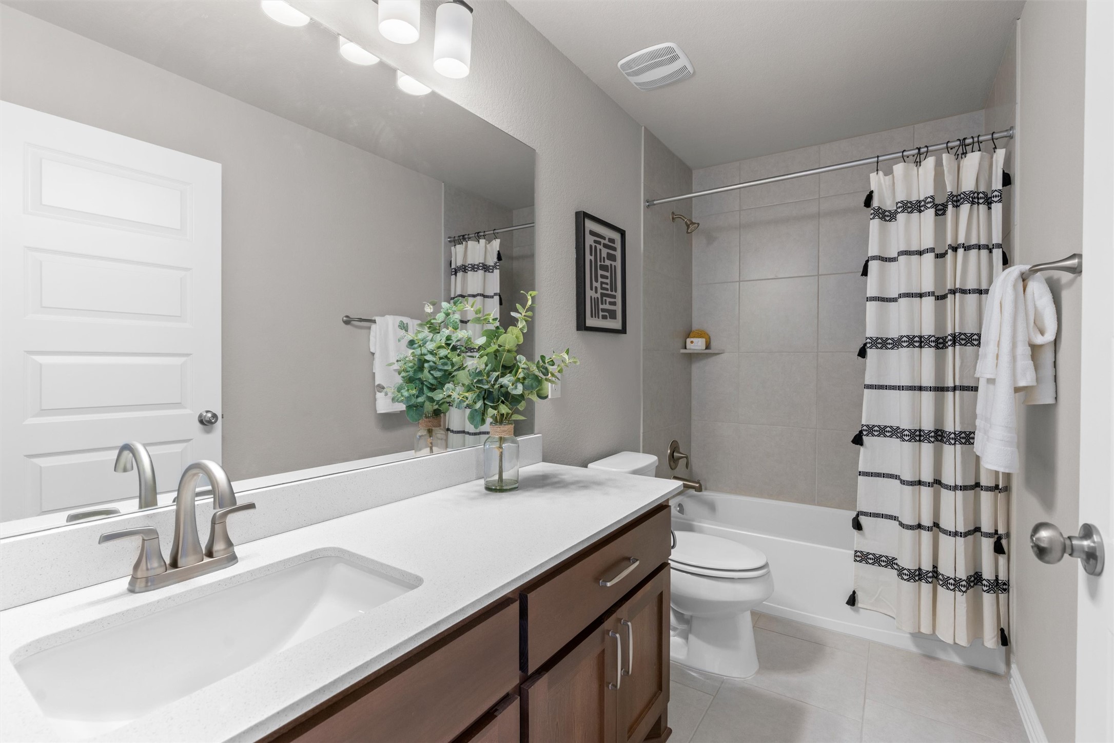 4216 Mercer Road Georgetown, TX 78628 - Photo 23 of 40 Full bath with vanity, shower / bathtub combination with curtain, and light tile floors