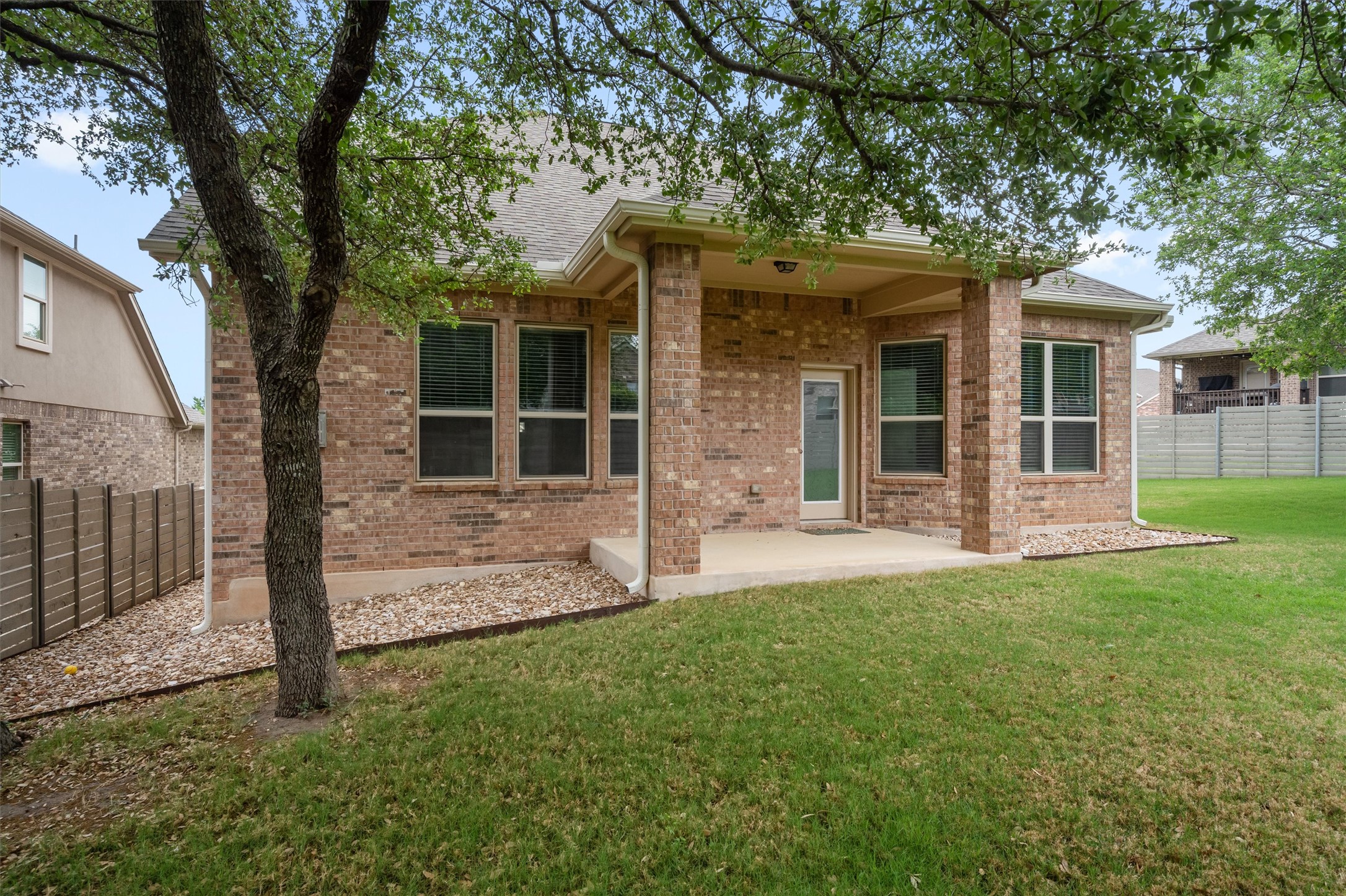 4216 Mercer Road Georgetown, TX 78628 - Photo 30 of 40 Rear view of property featuring a patio and brick siding