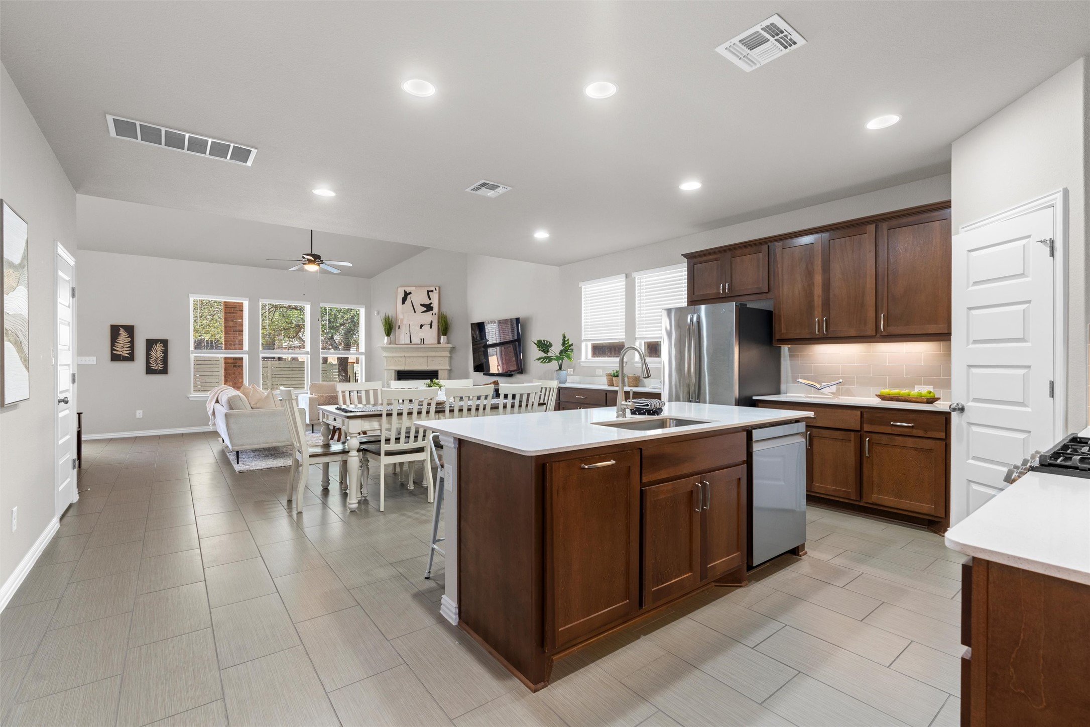 4216 Mercer Road Georgetown, TX 78628 - Photo 8 of 40 Spacious open-concept kitchen designed for both everyday living and entertaining, featuring a large center island with bar seating, ample cabinetry, and sleek countertops