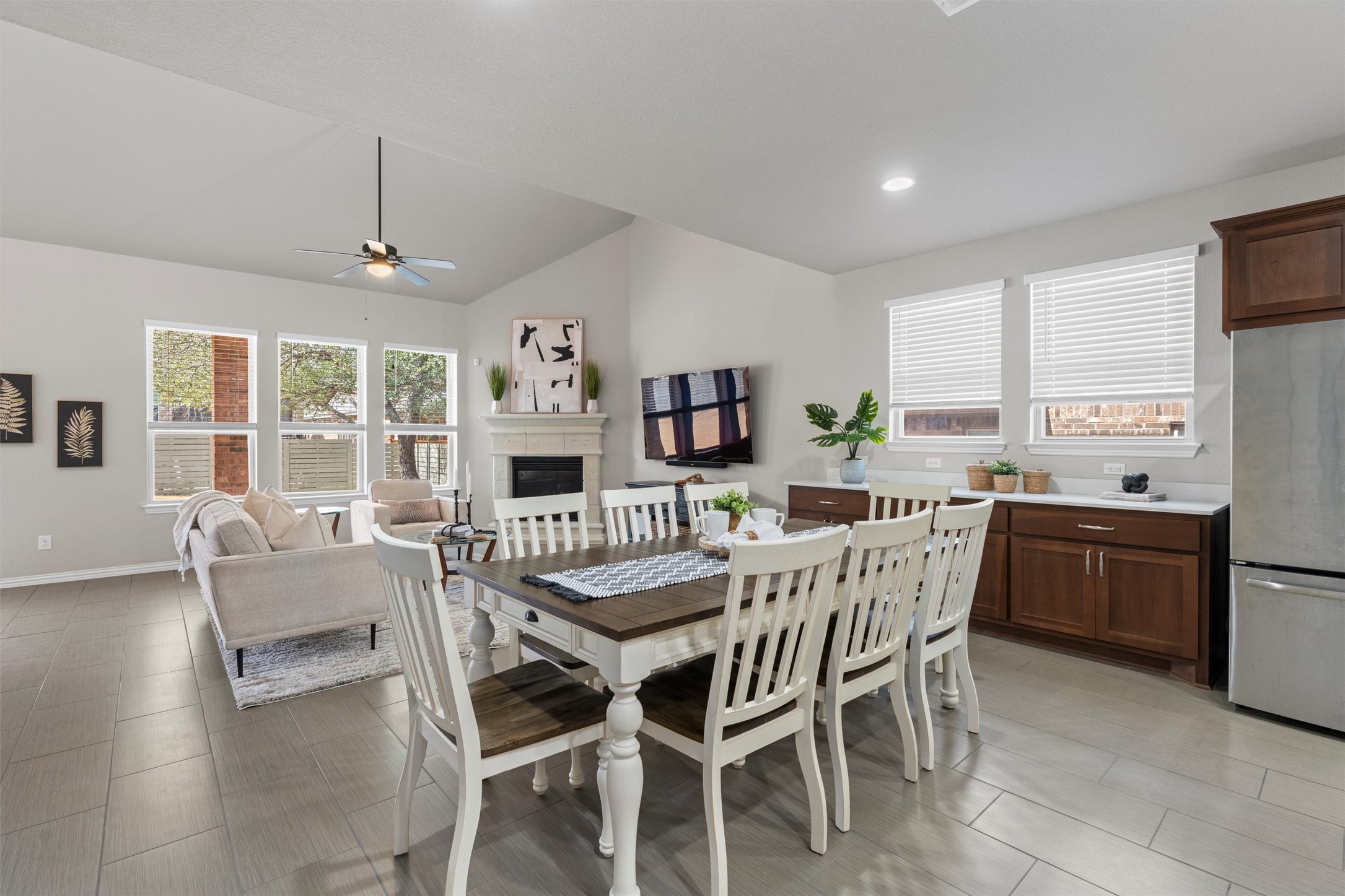 4216 Mercer Road Georgetown, TX 78628 - Photo 10 of 40 Dining room featuring ceiling fan, a fireplace, lofted ceiling, and recessed lighting