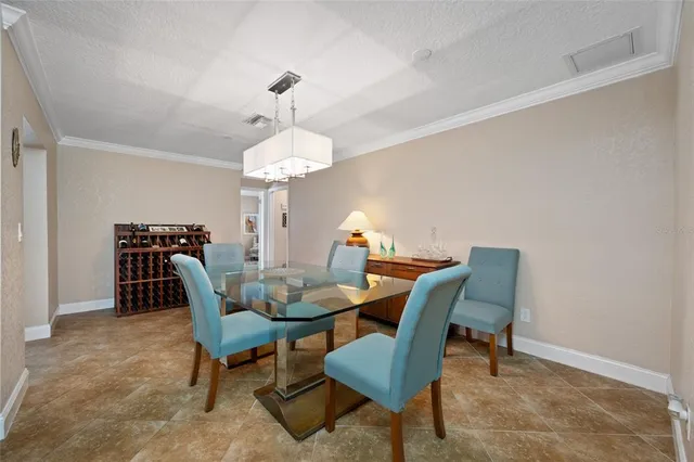 a view of a dining room with furniture and chandelier