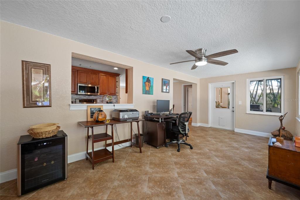 12957 90th Terrace Seminole, FL 33776 - Photo 17 of 31 a view of a workspace with furniture and a window