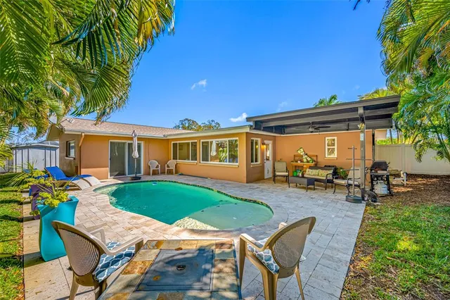 a view of a house with backyard sitting area and garden
