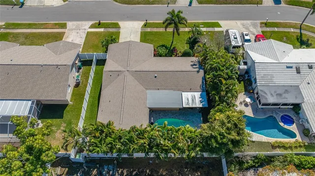 an aerial view of a house with garden space and street view