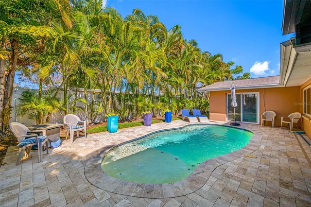 a view of a house with backyard porch and sitting area