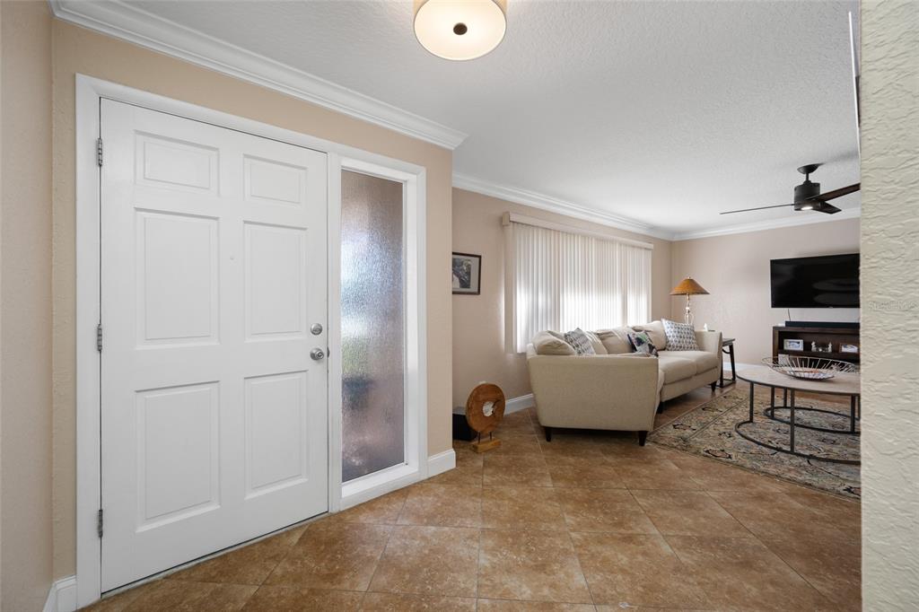 12957 90th Terrace Seminole, FL 33776 - Photo 4 of 31 a living room with furniture and a flat screen tv