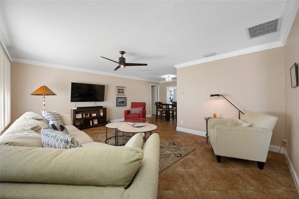12957 90th Terrace Seminole, FL 33776 - Photo 6 of 31 a living room with furniture and a flat screen tv
