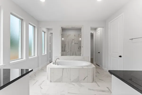 a bathroom with a bathtub and a sink