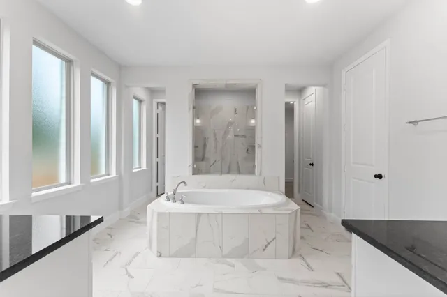 a bathroom with a bathtub and a sink