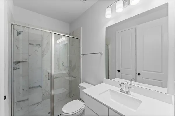 a bathroom with a sink toilet and shower