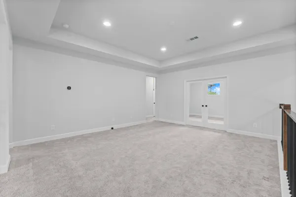 an empty room with a projector and white walls