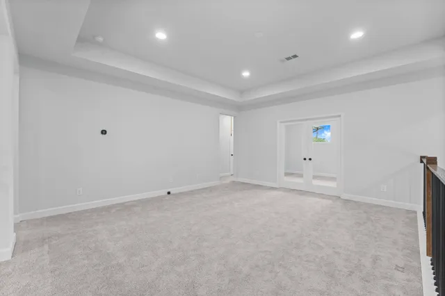 an empty room with a projector and white walls