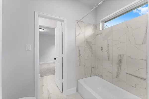 a bathroom with a bathtub and shower